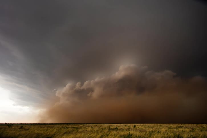 A dust storm runs over the field