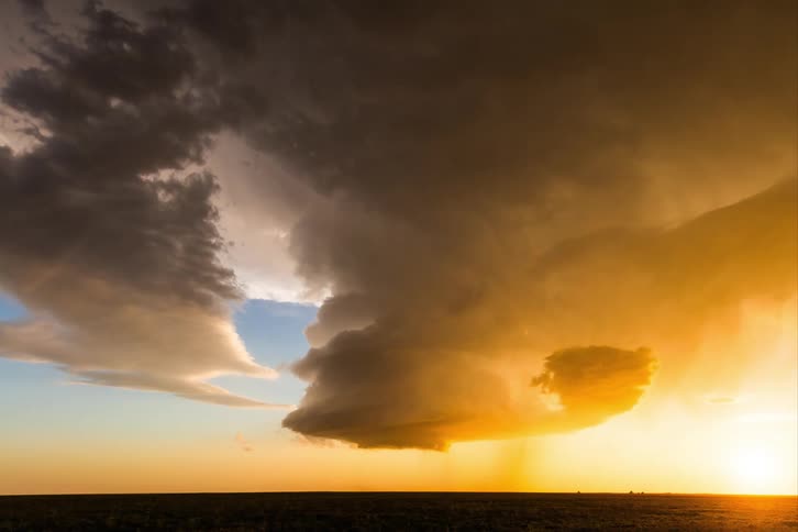 A large tornado forms on the landscape