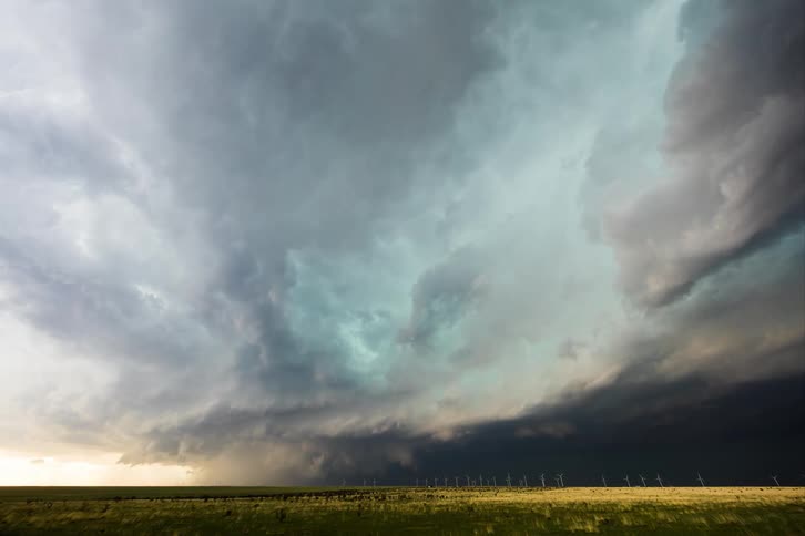 Dark storm clouds move across the sky as lightning flashes