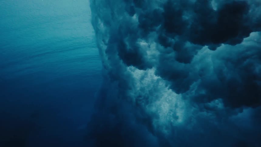 Crashing wave creates obscuring area underwater