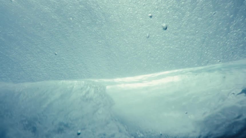 Inside the sea a wave breaking in slow motion