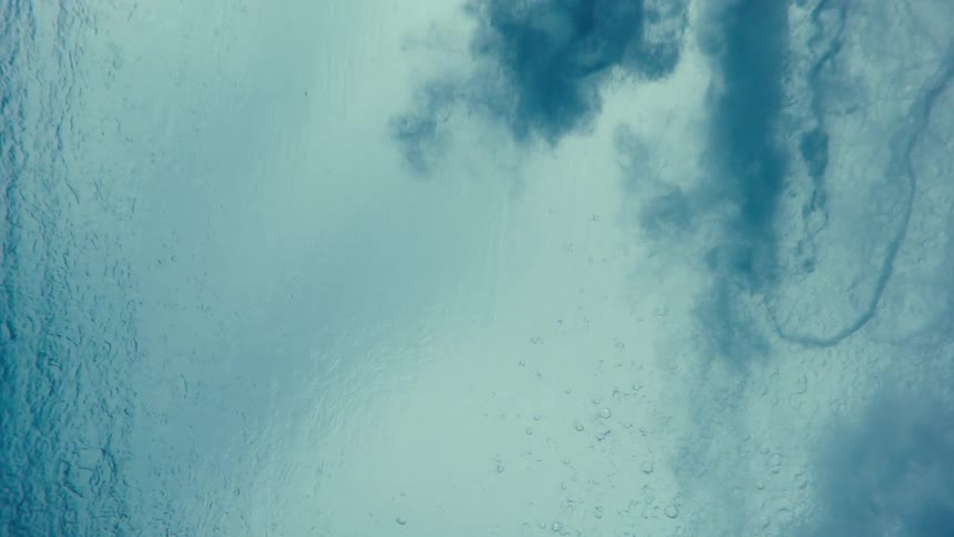 Underwater view of an ocean wave passing overhead