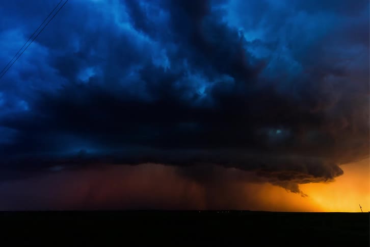 As storm clouds gather ominously overhead lightning streaks across the darkened sky heralding the imminent arrival of a powerful hurricane
