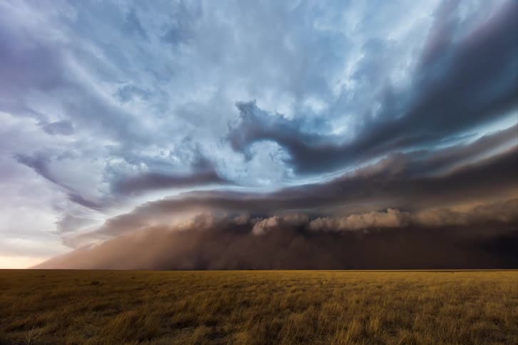 A large supercell and haboob flows over the landscape