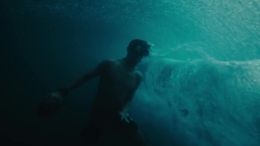 A wave washes over a diver