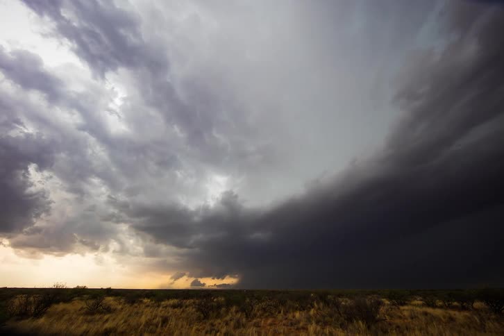 Time lapse of dark storm clouds moving across a field