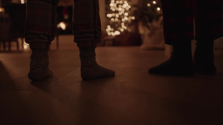 Closeup of feet in socks on a wooden floor