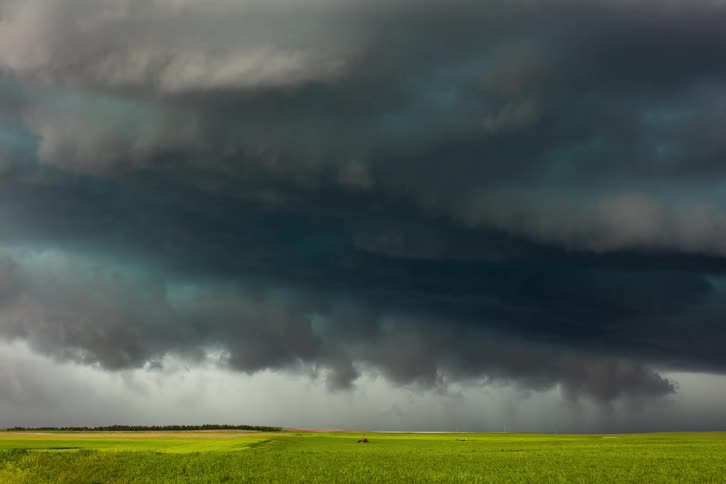 Time lapse of dark clouds rolling across a grassy field