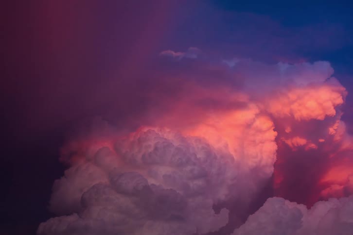 A storm of angry clouds with lightning and thunder lighting up the sky