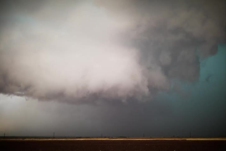 Time lapse of storm clouds and lightning over a plain