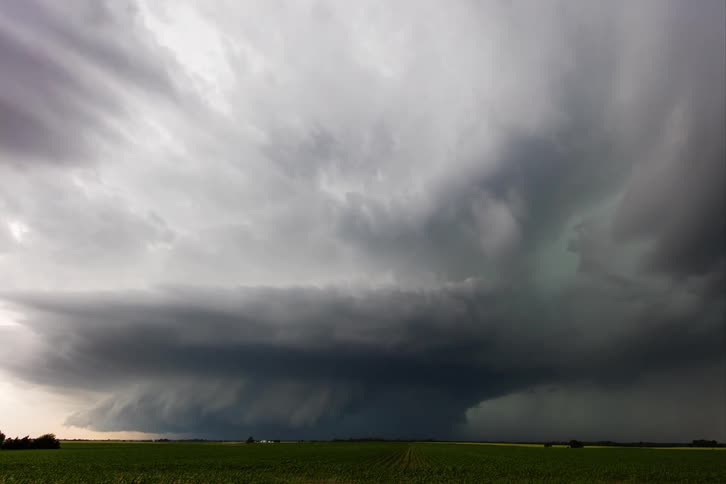 A hurricane approaching furiously over a rural field