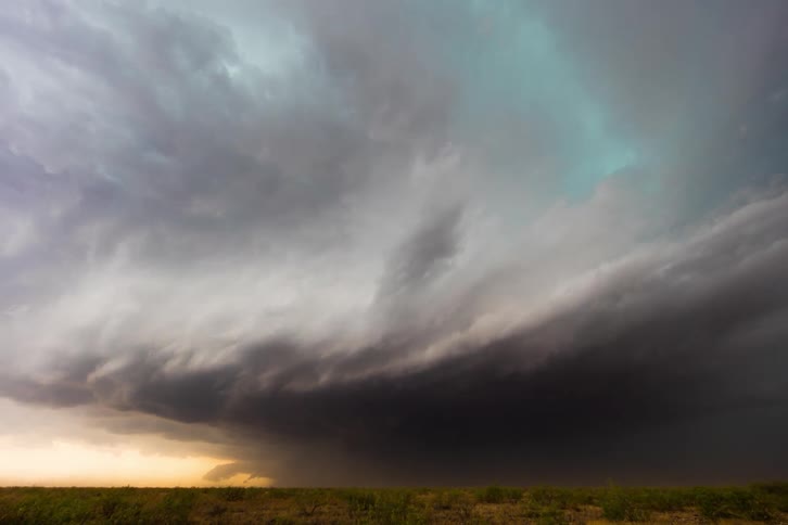 Dark storm clouds move across the sky as a super cell moves over the ground