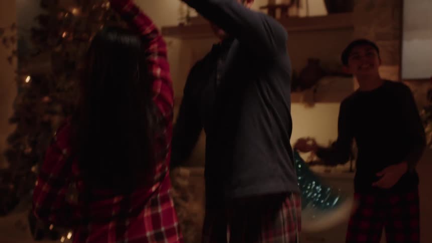 A couple dancing in the living room on christmas eve