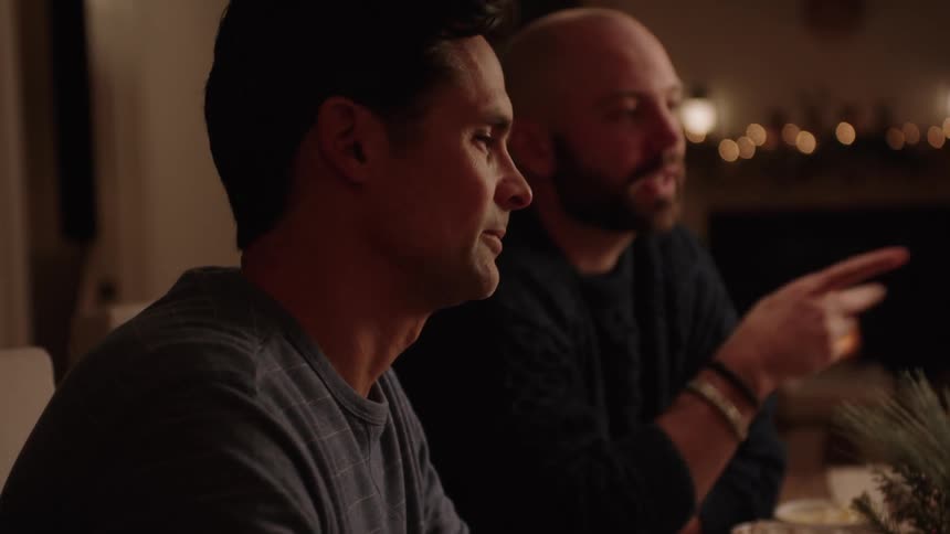 Portrait of two men sitting at a christmas table talking