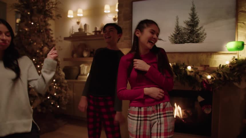A family dancing in the living room at a christmas party