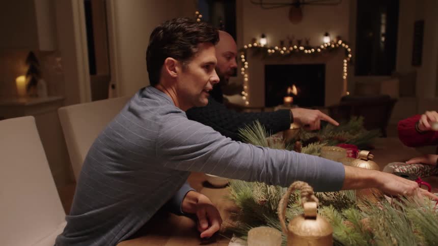 Family sitting at the table talking and smiling a lot at christmas time