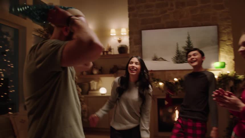 Happy family dancing together in the living room at christmas