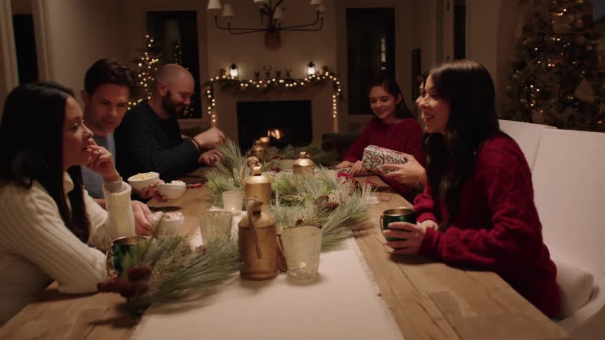 Friends gathered around the table with coffee during the holidays