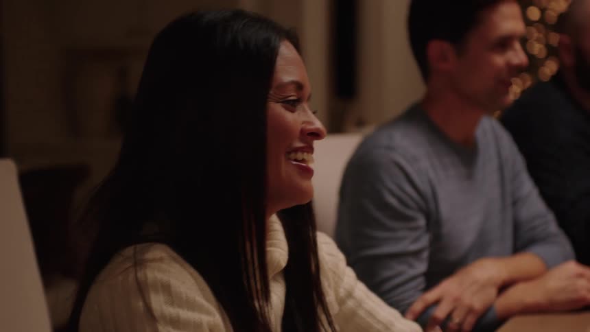 People talking and laughing around a christmas table