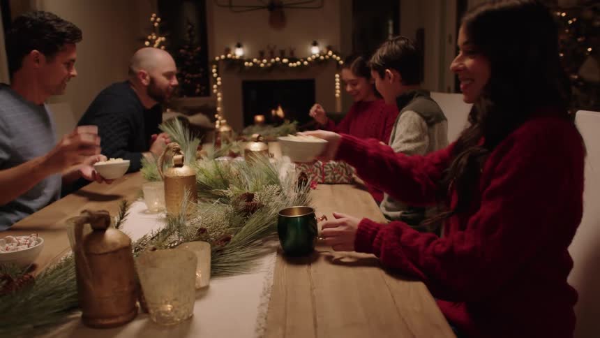 Friends gathered around the table with dessert during the holidays