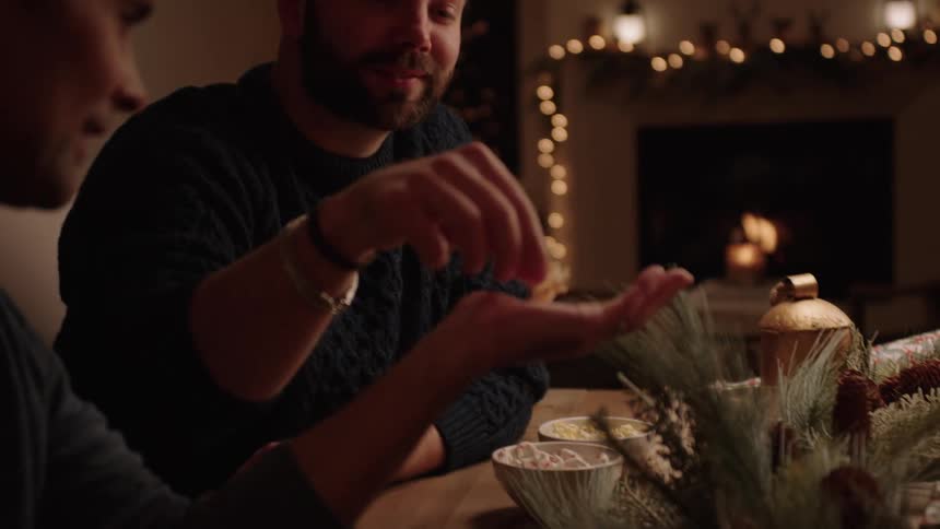 Men talking and sitting at a table decorated with christmas decorations