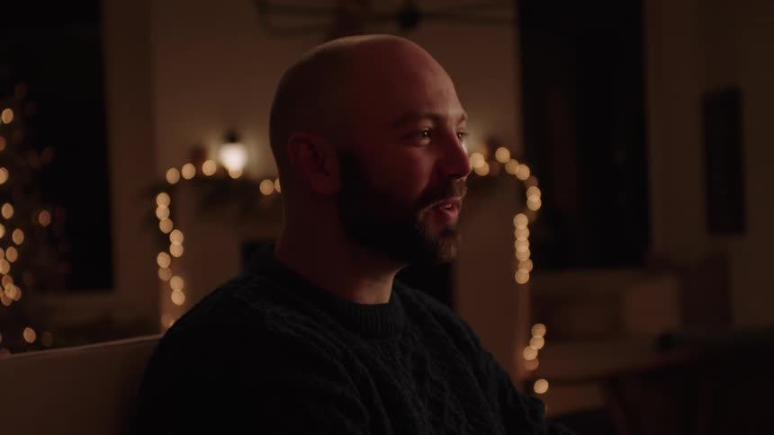 A man talking to other people sitting at the table