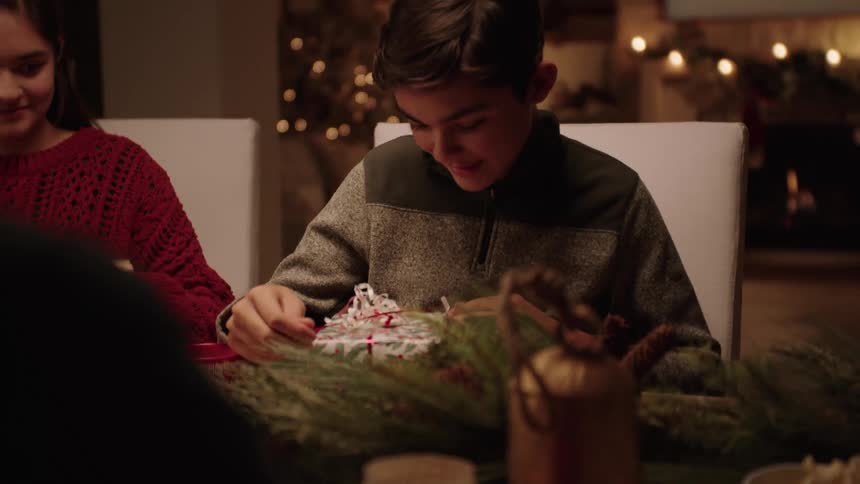 A family wrap christmas gifts at home