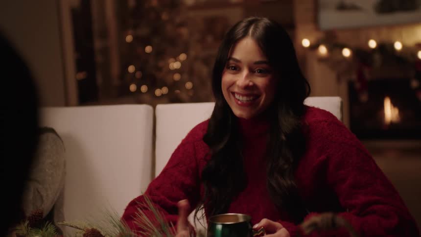 A happy girl talking to someone sitting at the table
