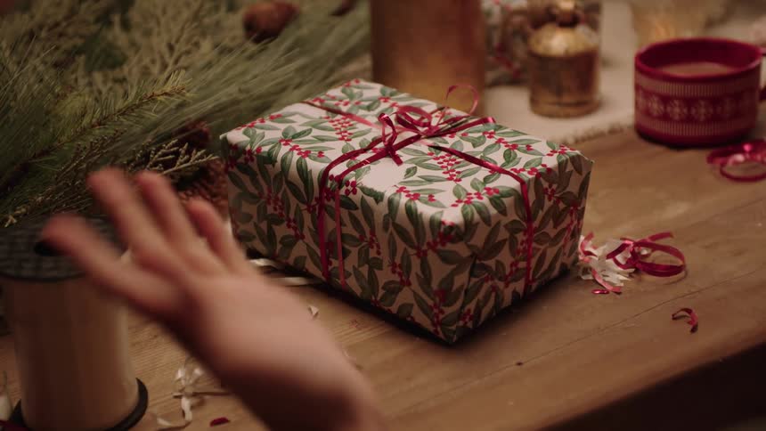 Close up of a person wrapping a christmas gift