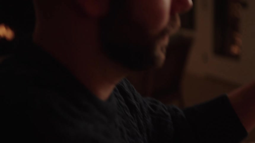 Man having fun wrapping gift at christmas night