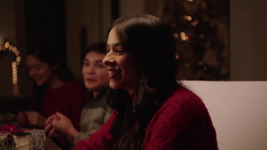 An adult woman talking to teenagers at a table