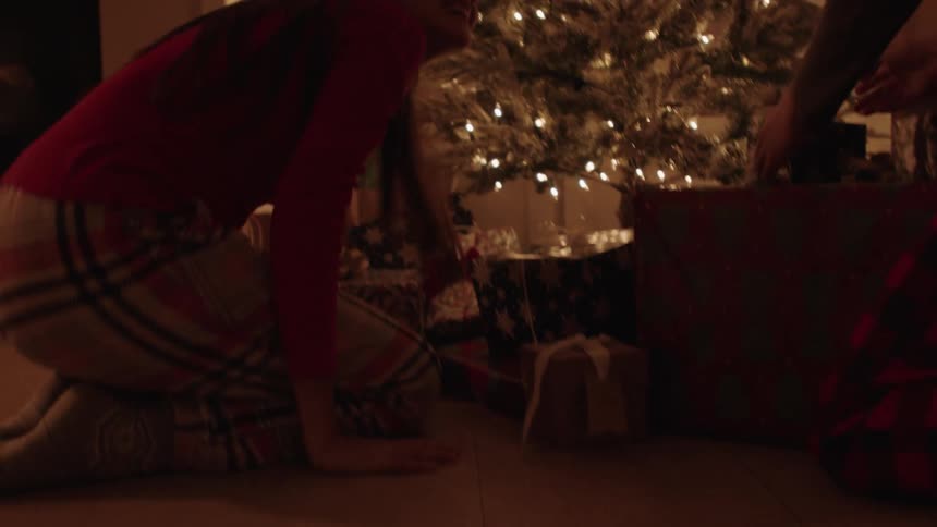 Siblings run to open their presents at christmas morning