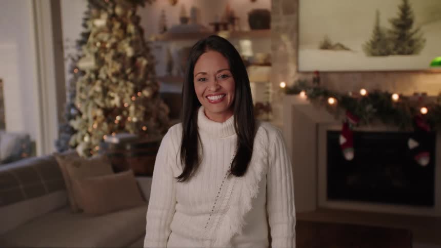 Portrait of a smiling woman standing in a christmas room
