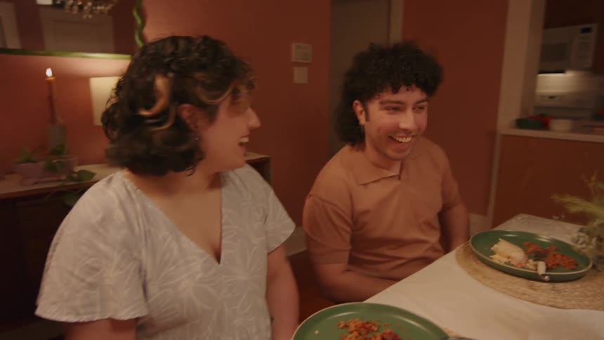 A family has fun having dinner together