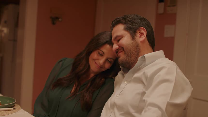 Portrait of a couple sitting and smiling affectionately