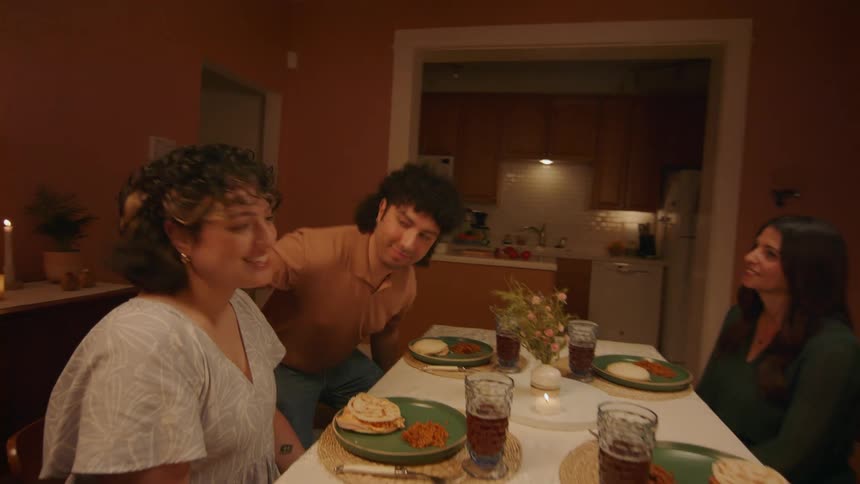 Two couples sitting for dinner together at home
