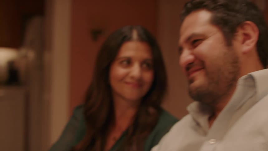 Young couple hold hands in the dining room
