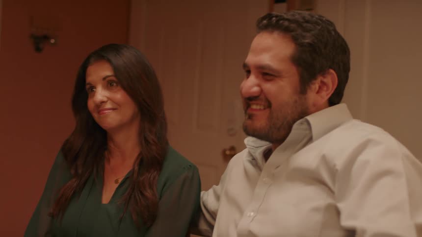 Portrait of a couple sitting and talking to other people