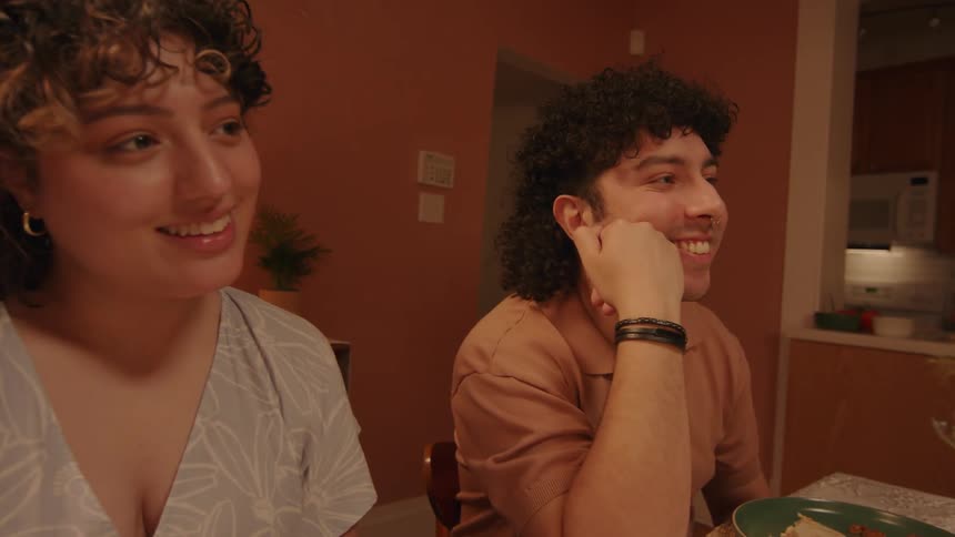 Two couples have a lively conversation after dinner