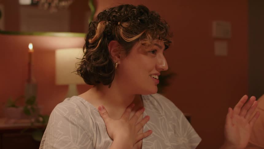 Happy woman excitedly talking in a family reunion