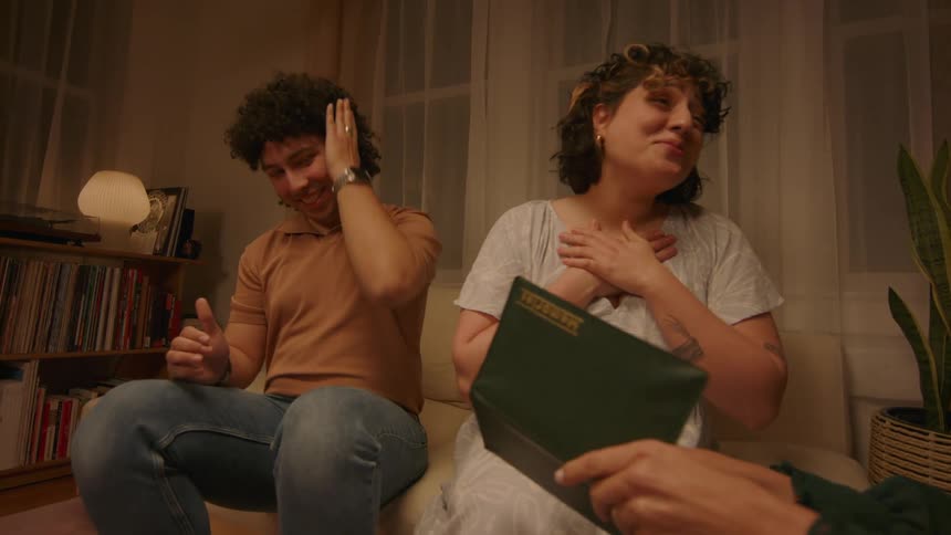 A couple looking at family photos sitting in the living room