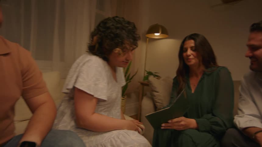 Two couples sharing memories in the living room