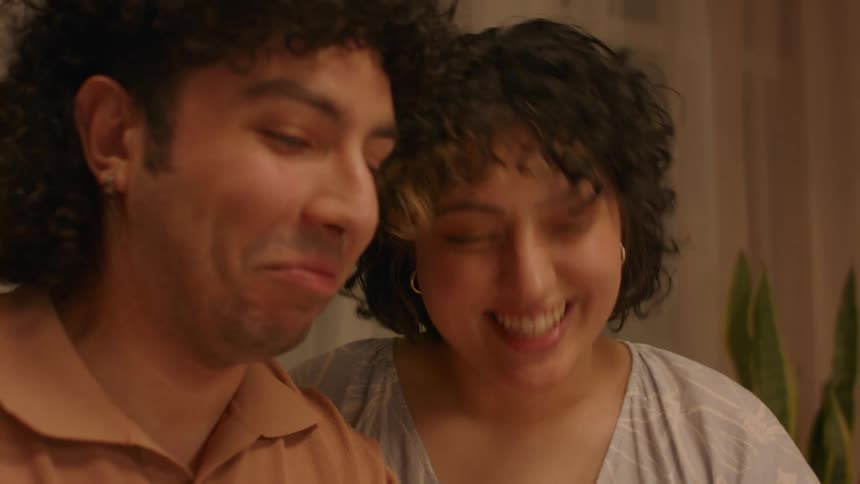 Young couple look at each other with amusemet