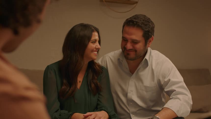 Couples sitting in the living room talking smiling