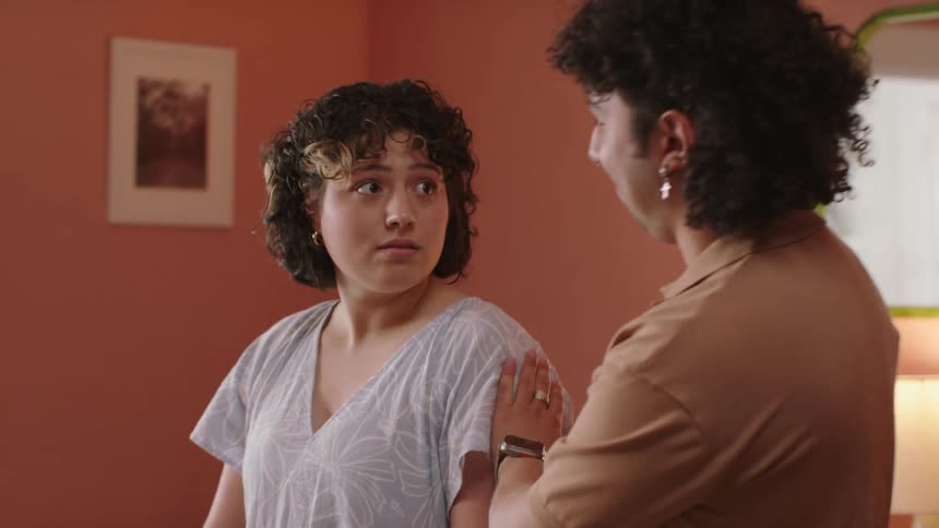 A man hugging a nervous woman in the dining room
