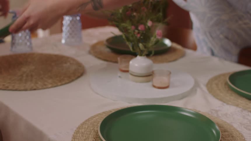Couple overturning glasses and plates at a table