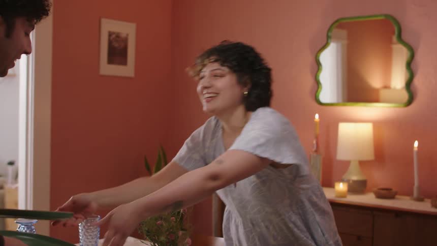 A man and a woman setting the dining table