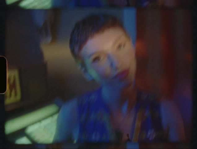Young lady in blue gown dancing in the club at night