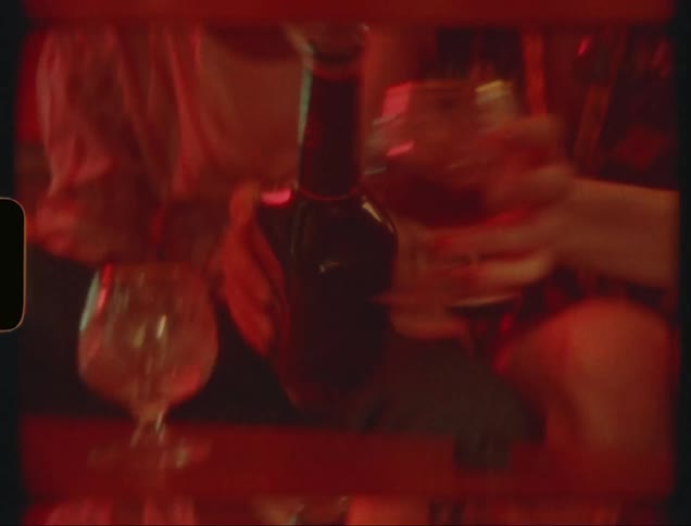 Dating couple sitting on the sofa serving a drink