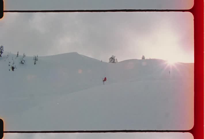 Person falls down while skiing on the snow during the day